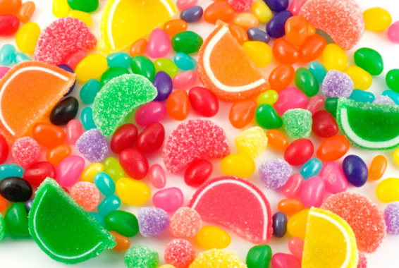 An assortment of colorful candy on full frame background with jellybeans, gumdrops and other jelly candies