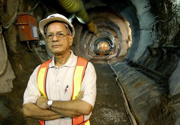 NEW DELHI, INDIA: Managing Director of Delhi Metro Rail Corporation (DMRC) E. Sreedharan, poses after watching a Rock Tunnel Boring Machine (TBM) break through the last tunnel section at Chawri Bazaar in New Delhi, 03 September 2004. The 11 km long underground corridor of the Metro running from Delhi University and Central Secretariat (line II) involves tunnelling over a distance of 4 kms using a TBM and Earth Pressure Balance Machine (EPBM). The undergroung Metro Corridor is being openied in two stages with the 4 km Delhi University to Kashmere Gate section being opened in December 2004, and the extension to the Central Secretariat opening forecast for June 2005. AFP PHOTO/Prakash SINGH (Photo credit should read PRAKASH SINGH/AFP/Getty Images)