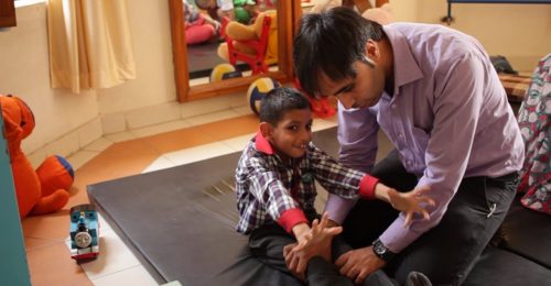 Physiotherapist helps a differently abled boy