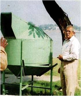 Mr. Ghosh with his previous model of the midsize bin. It is made of fibre glass and is still used at Ramakrishna Belur Math, West Bengal.