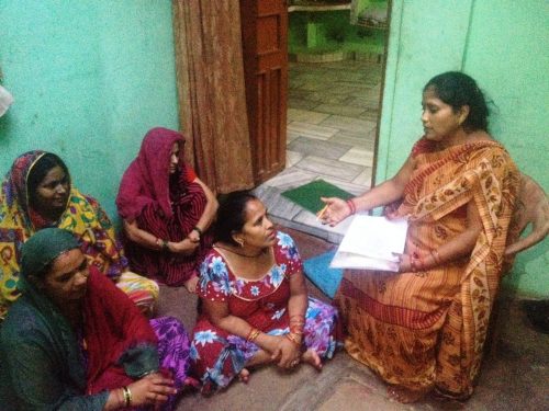 Sangeeta Awasthi speaks to her neighbours about availing benefits under the Swachh Bharat Mission to build toilets.