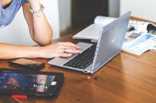 woman-hand-smartphone-laptop