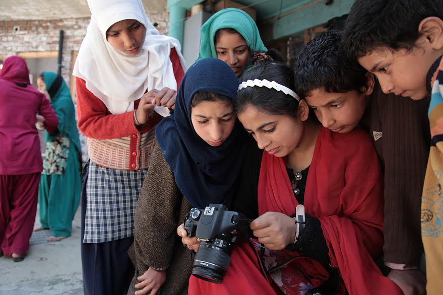 Girls learning to operate the camera at the Kupwara home.