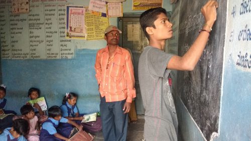 Kashinath explaining math at a child activity centre