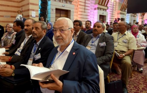 Tunisian Islamist Ennahdha Party leader Rached Ghannouchi (C) attends the discussions on May 22, 2016, in Hammamet on the third-day of the Ennahdha congress. Around 1,200 Ennahda delegates will meet over the weekend in Hammamet, south of Tunis, to discuss the party's future and adopt economic, political and social roadmaps. / AFP PHOTO / FETHI BELAID