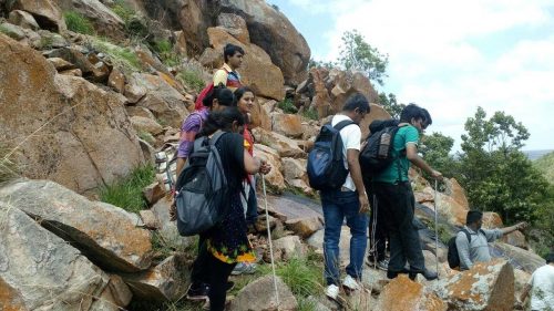 One blind and one hearing-impared participant is teamed with one volunteer for the trek