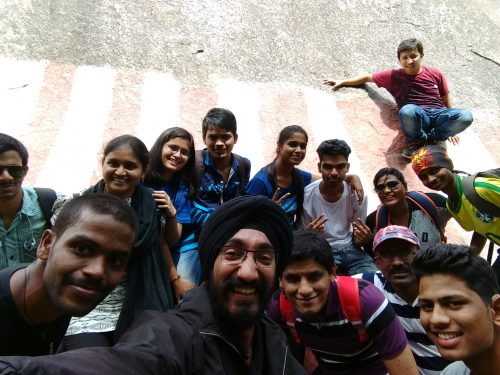 The trekkers take a selfie at the big boulder in Ramanagara