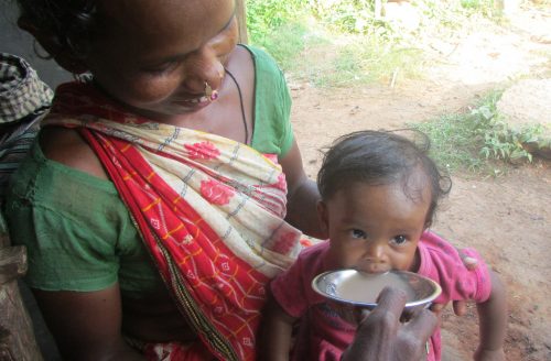 A tribal woman feeding her son nutritious ragi soup. (Credit: Rakhi Ghosh\WFS)