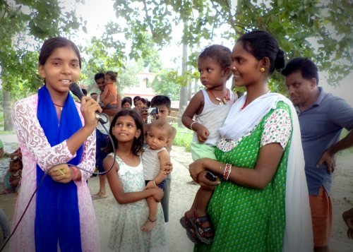 Nisha conducts a community meeting in a village in Bihar