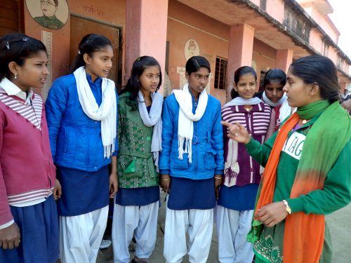 Nisha in discussion with her girls at a local school