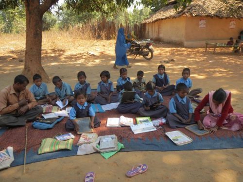 The school initially operating under a tree.