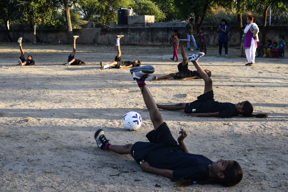 Girls do warm up during practice, in Hasiyawas.