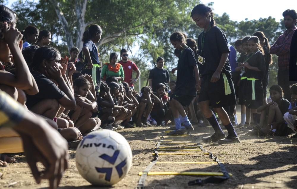 12 — year — old Reeta gets training from coach during a football camp, in Meeno Ka Naya Gaon.