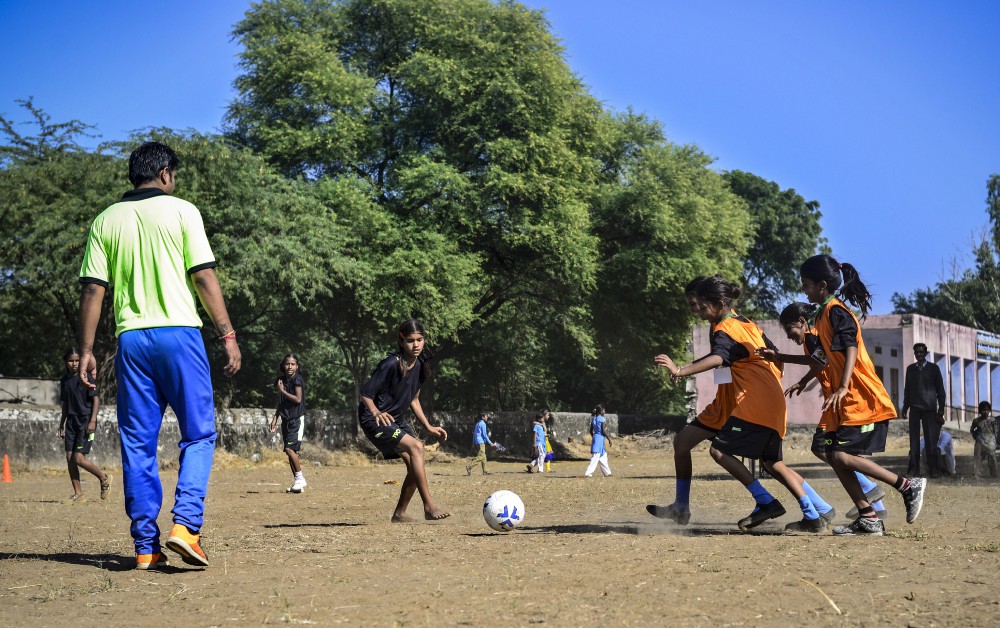 Girls play a friendly match during football camp, in Meeno Ka Naya Gaon.