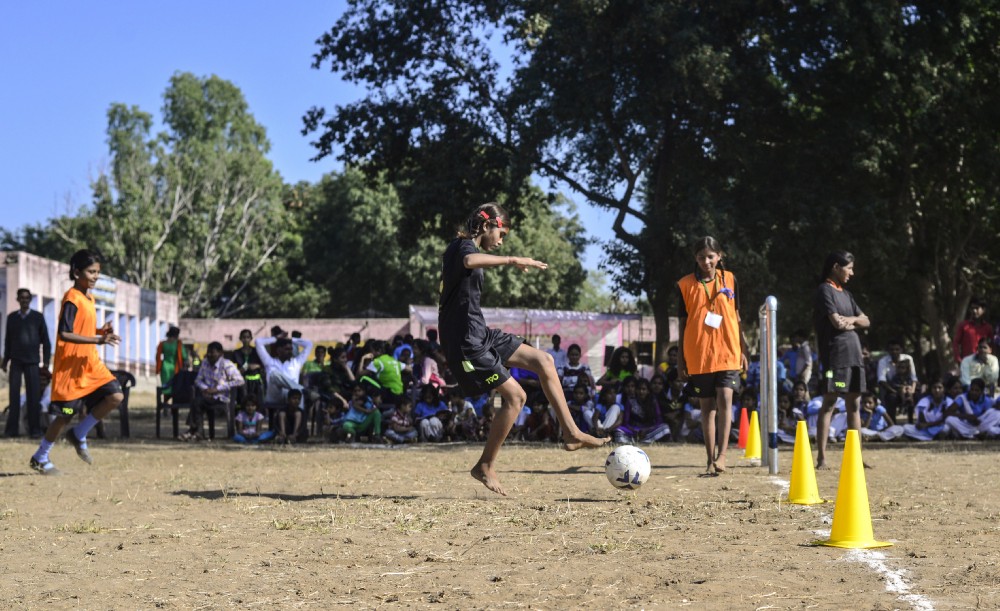 Girls play a friendly match during football camp, in Meeno Ka Naya Gaon.