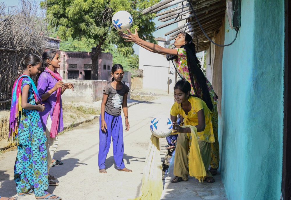 Anjali (yellow dress) along with other friends play during school lunch break, in Meeno Ka Naya Gaon.