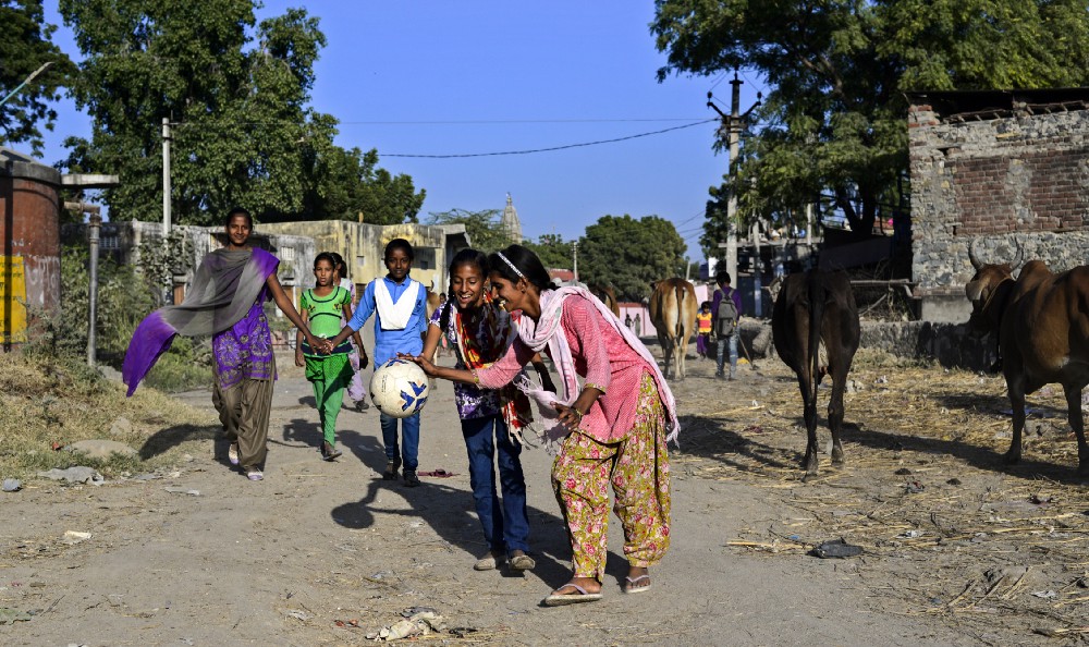 Students of 9th class; Sunita and Pooja play around on the way to ground, in Sakariya.