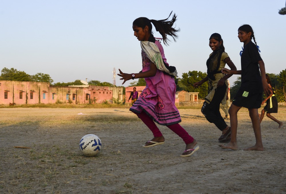 15 — year — old Pooja chase the ball during a evening practice, in Sakariya.