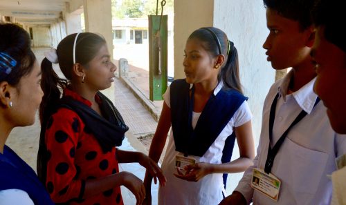 Payal Mishra (in red kurta) talks to Vaishnavi Sakhre (3rd from left) and Chandan Wasey (4th from left) at Zilla Parishad High School in Saoli block’s Patri village. (Credit: Dilnaz Boga\WFS)