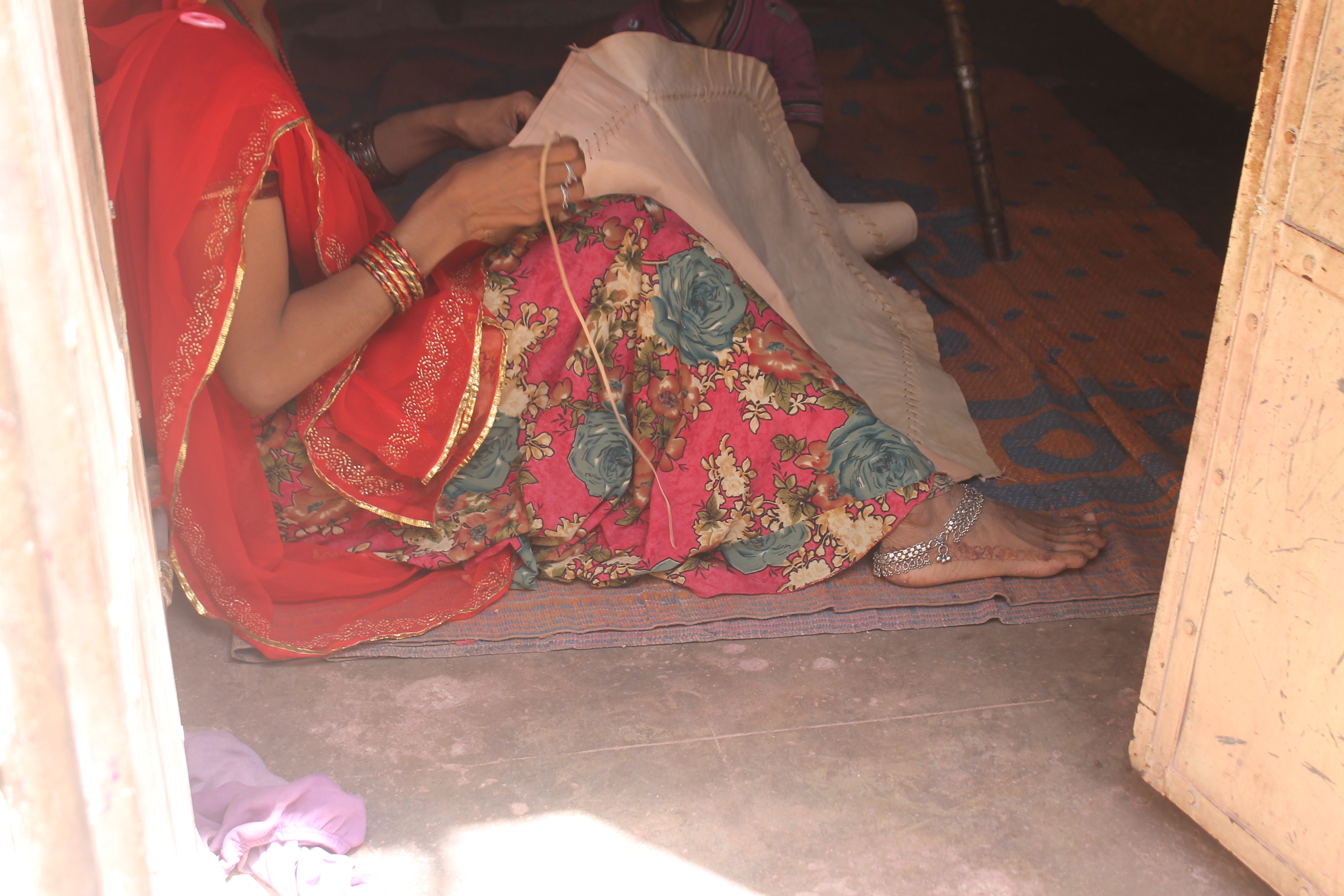 Artisan stitching the pattern for the Jodhpuri chappal