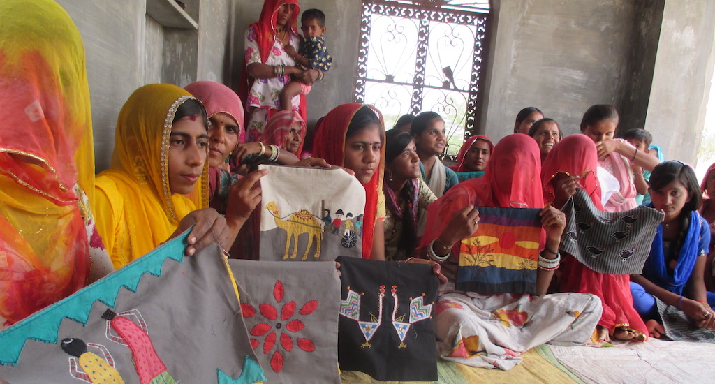 Women embroiders show their latest work after a training workshop. (Photo by Tarun Kanti Bose)