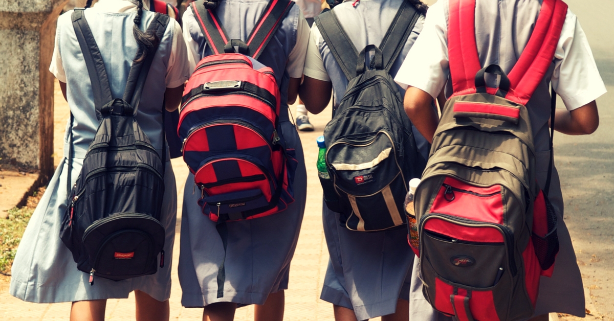 Children carry extremely heavy school bags. Picture Courtesy: Wikimedia Commons.