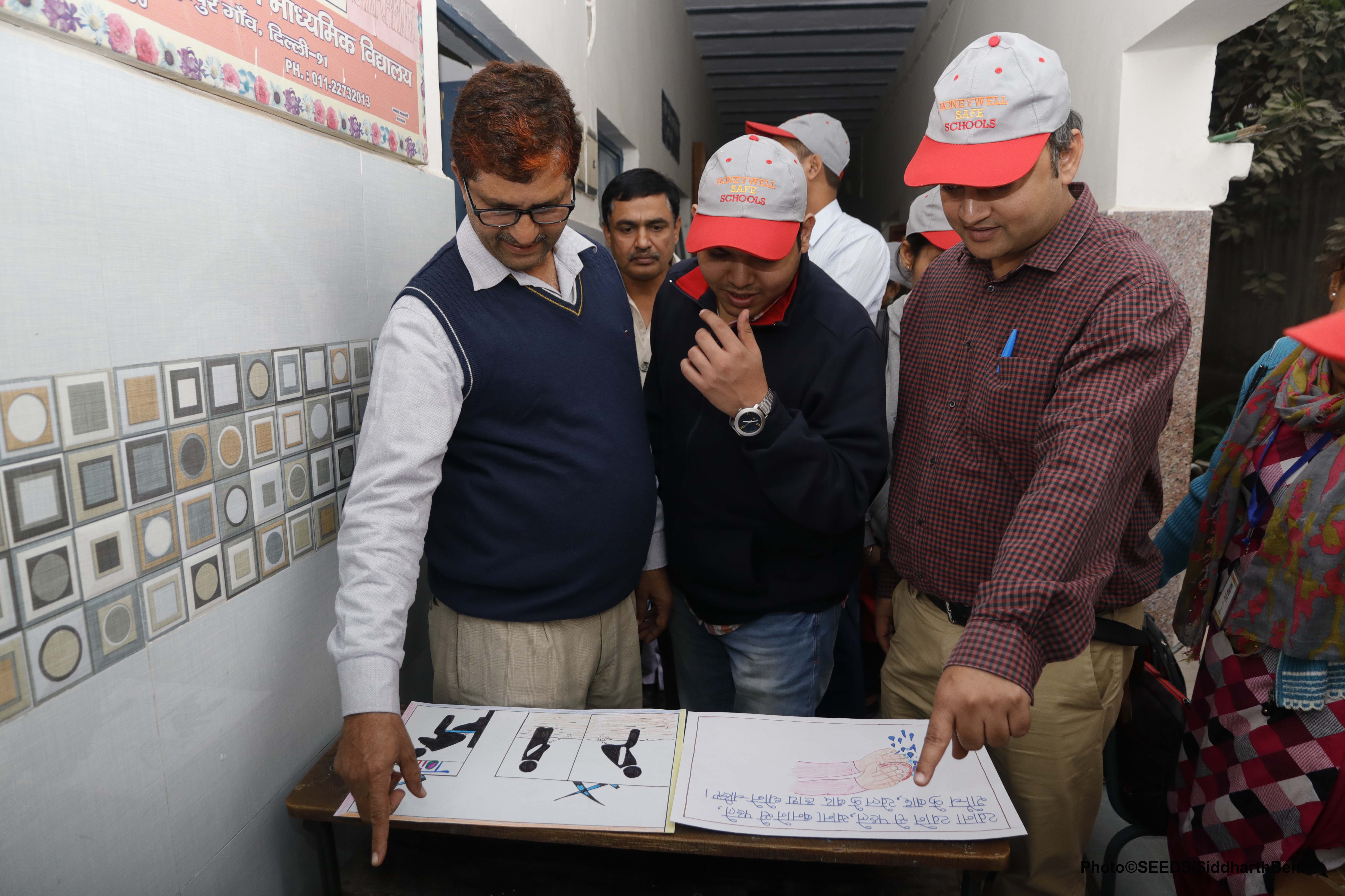 Experts and volunteers from SEEDS detailing safety measures to teachers in a government school. (Source: SEEDS)