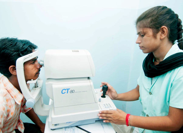 Patient taking an eye exam with an optometrist at AJEH. (Source: Milaap)