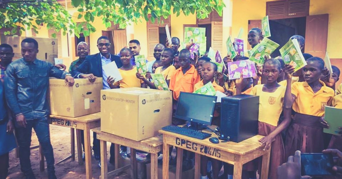 Richard Appiah Akoto (second from left) and his students receive computers donated to their school. (Source: Facebook/NIIT Ghana)