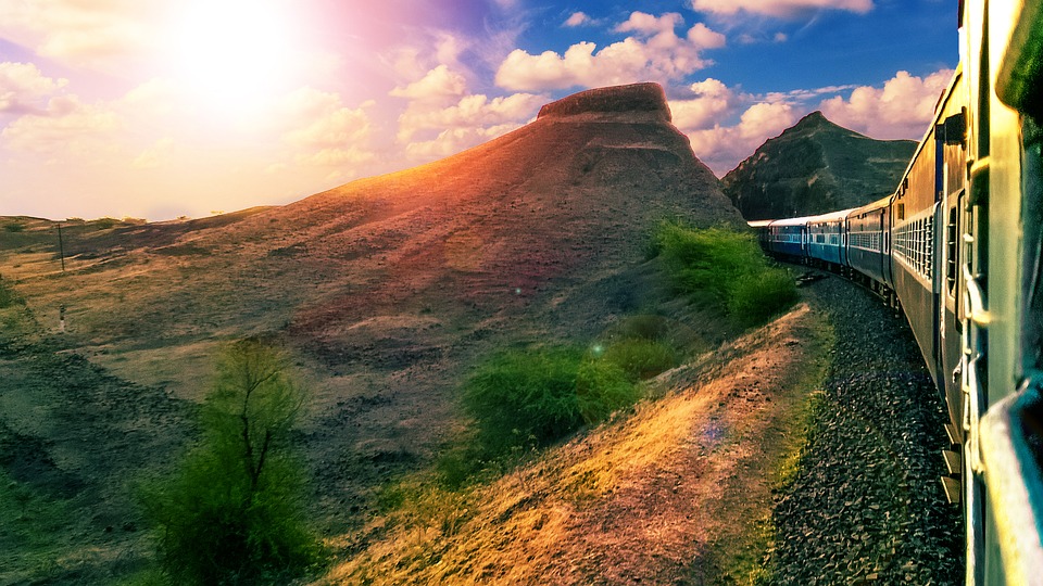 Rails running around hills and through mountains