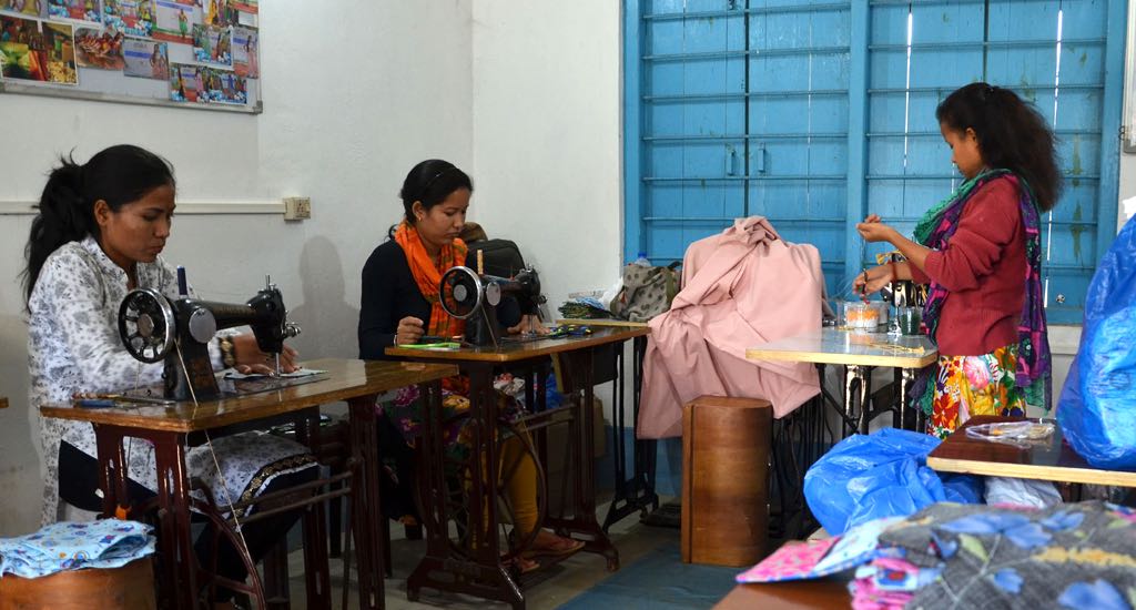 Young girls stitch reusable cotton pads, earning a livelihood. (Photo by Abdul Gani)