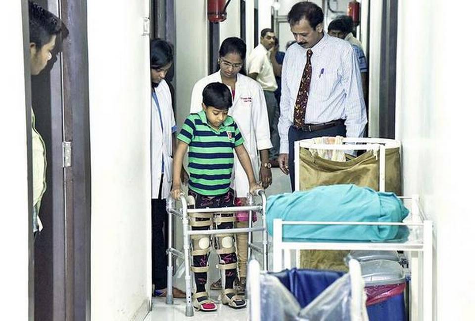 Eight-year-old Rohit Gehlot walking with support. (Source: Facebook/Adigos Stem Cells)  