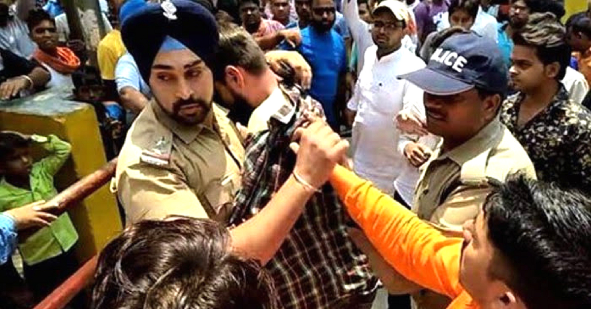 In the line of duty. Sub-Inspector Gangandeep shielding a Muslim man. (Source; YouTube)