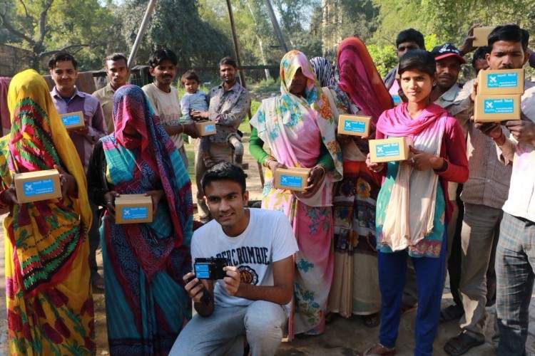 Ishan Malhotra posing with fellow villagers with his Pluto device. (Source: Ishan Malhotra)