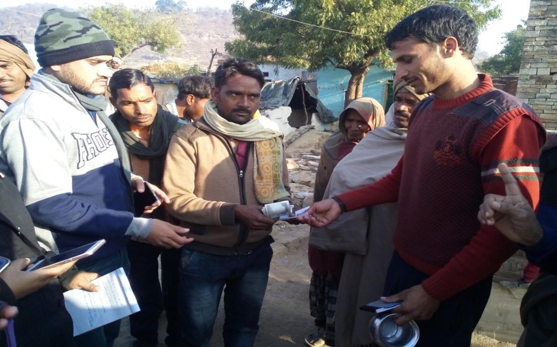 A villager being fined for defecating in the open. 