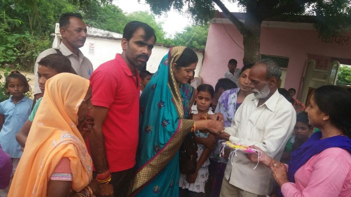 Local MLA tying a Swachhta Rakhi on Raksha Bandhan to a local who has constructed a toilet in his house. 