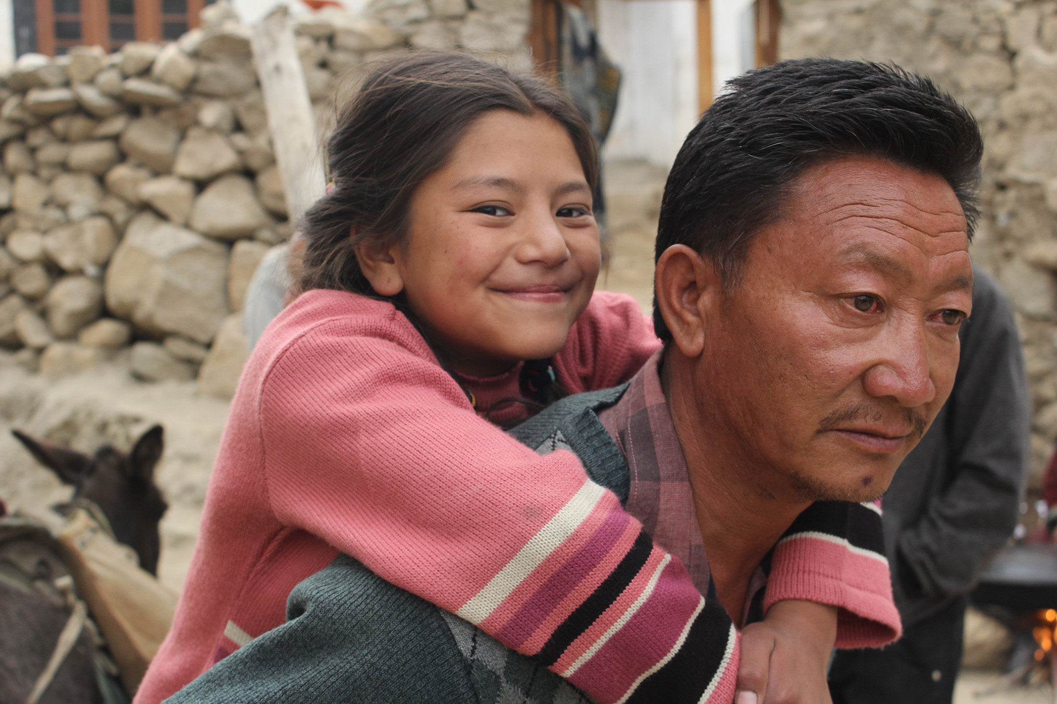 Chuskit going to school on her father's back. A still from the film. (Source: Chuskit) 