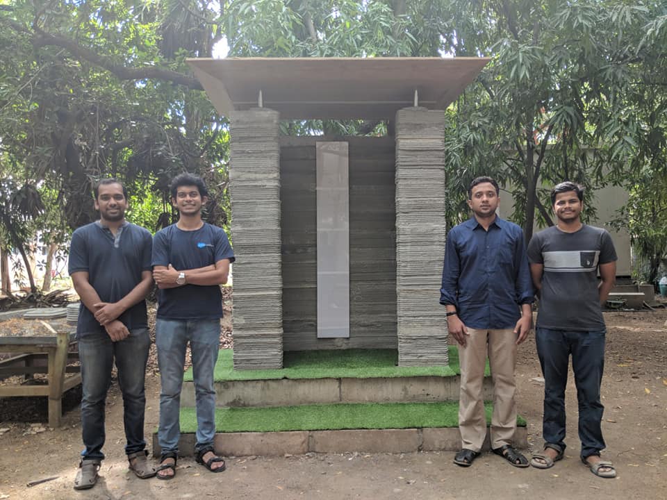 The team behind this latest breakthrough standing in front a structure they constructed using 3D printing construction technology. (Source: Facebook/SK) 