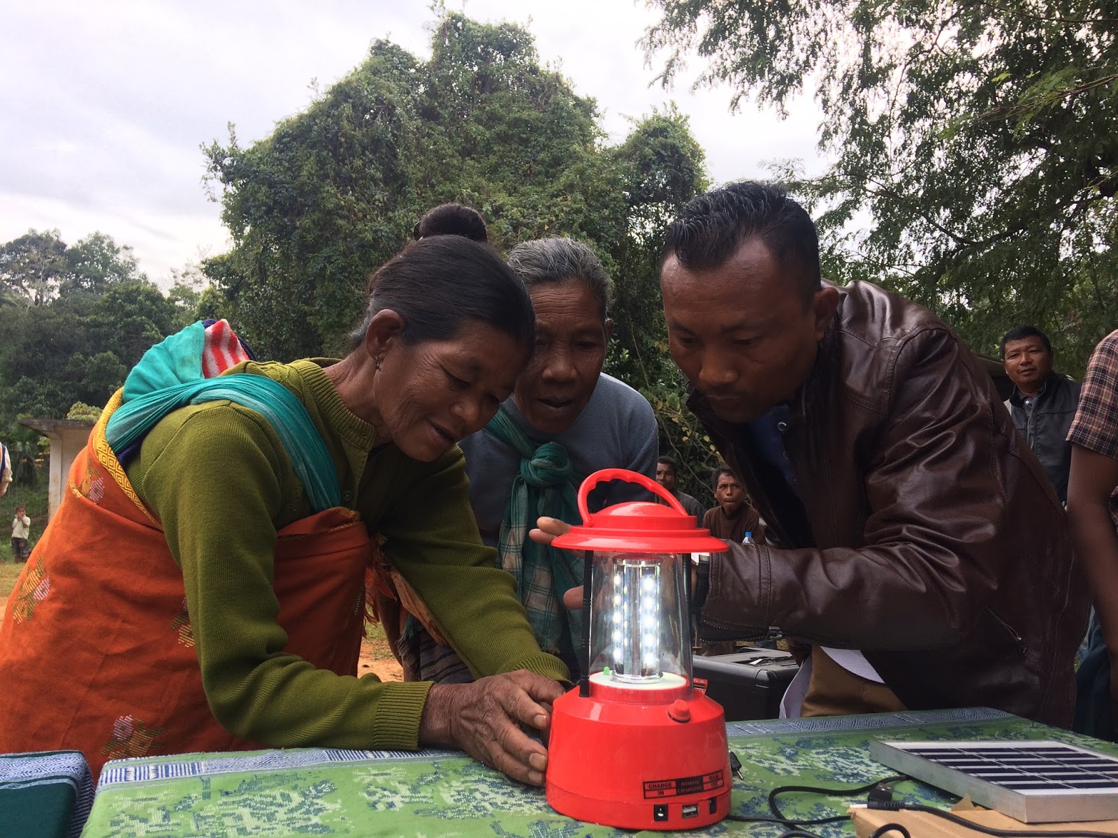 Locals learning how to operate a solar lantern.
