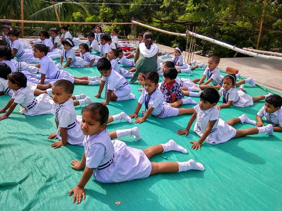 Students performing yoga. (Source: IPSRI)