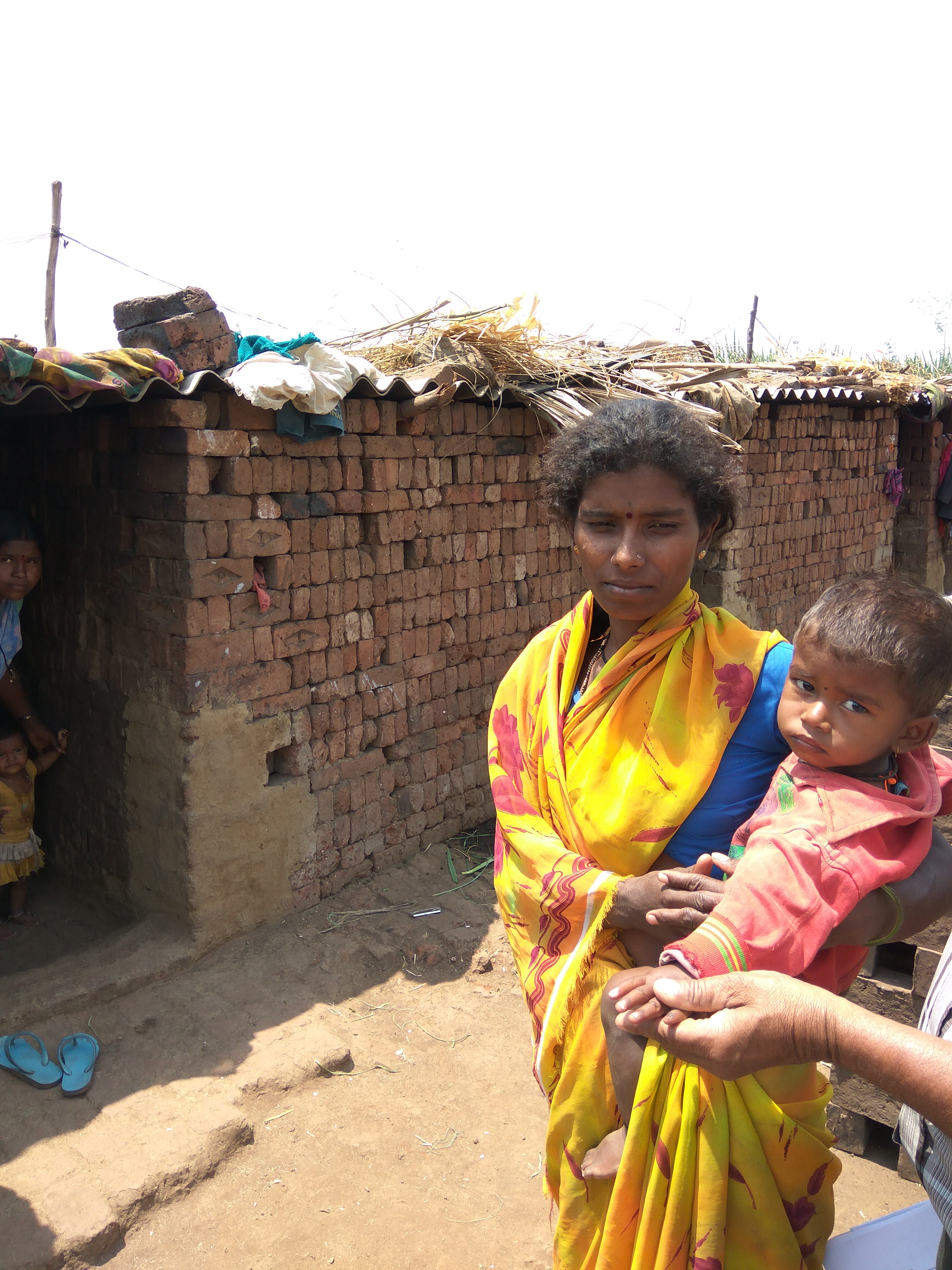 A sugarcane cutter and her child, who is being checked for immunisation. (Source: Ishan Pathak)