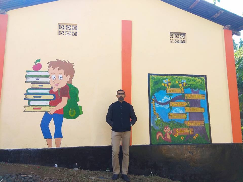 SDO Swapnil Tembe standing outside the renovated school. 