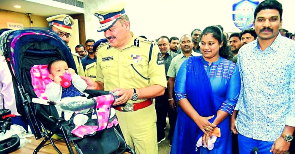 Priyanka (in Blue) looking over a senior police official at the two-month-old child. (Source: My Medical Mantra)
