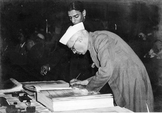 Jawaharlal Nehru signing the Constitution. (Source: Wikimedia Commons)