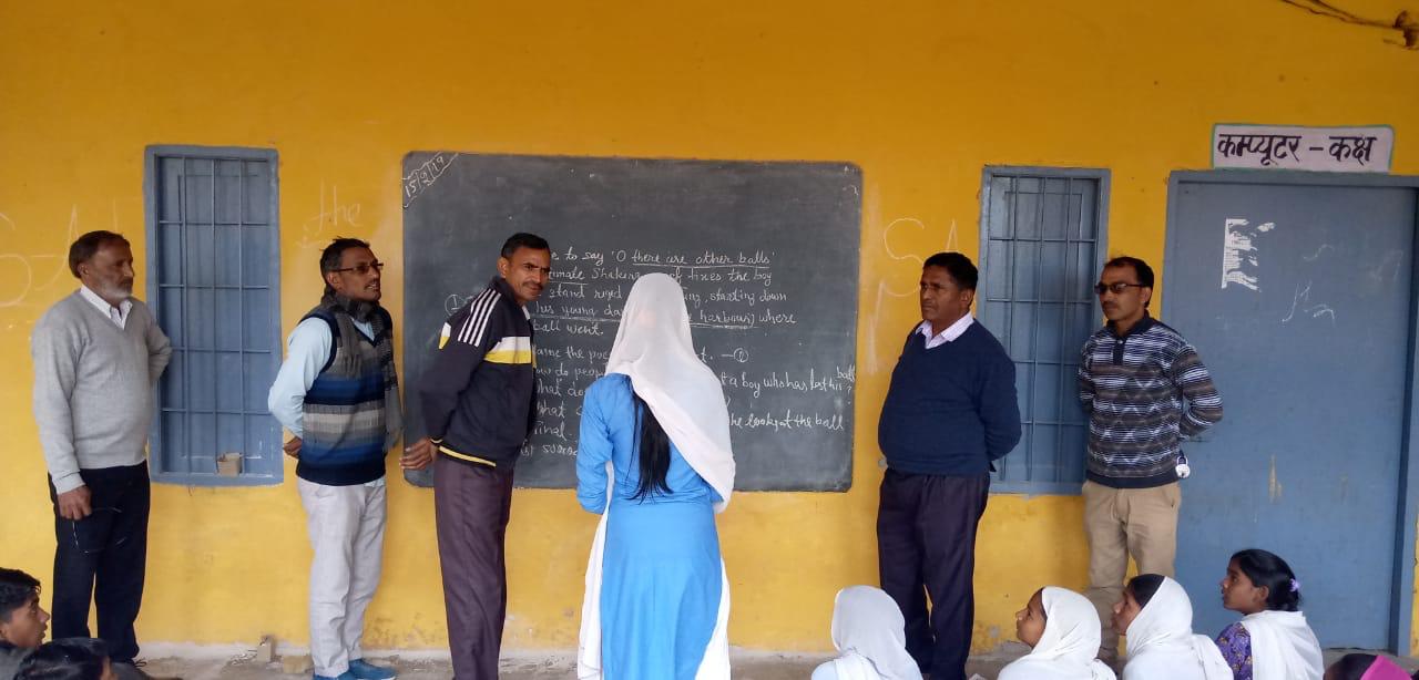 School monitoring visit: Officials on a random inspection. 