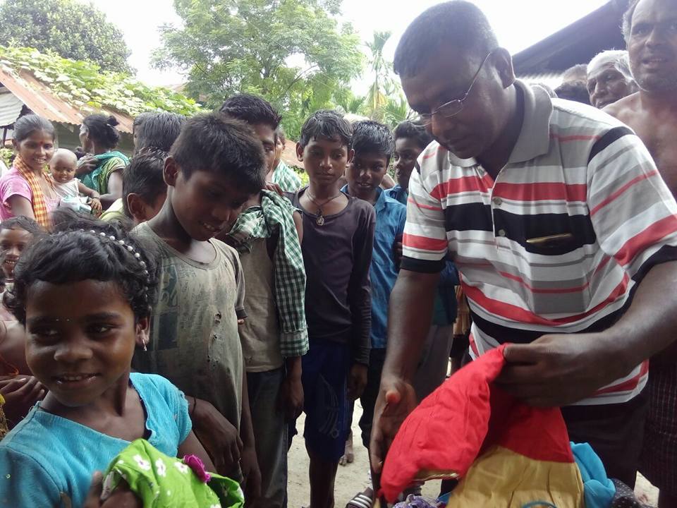 Distributing clothes to young children during a donation drive. 