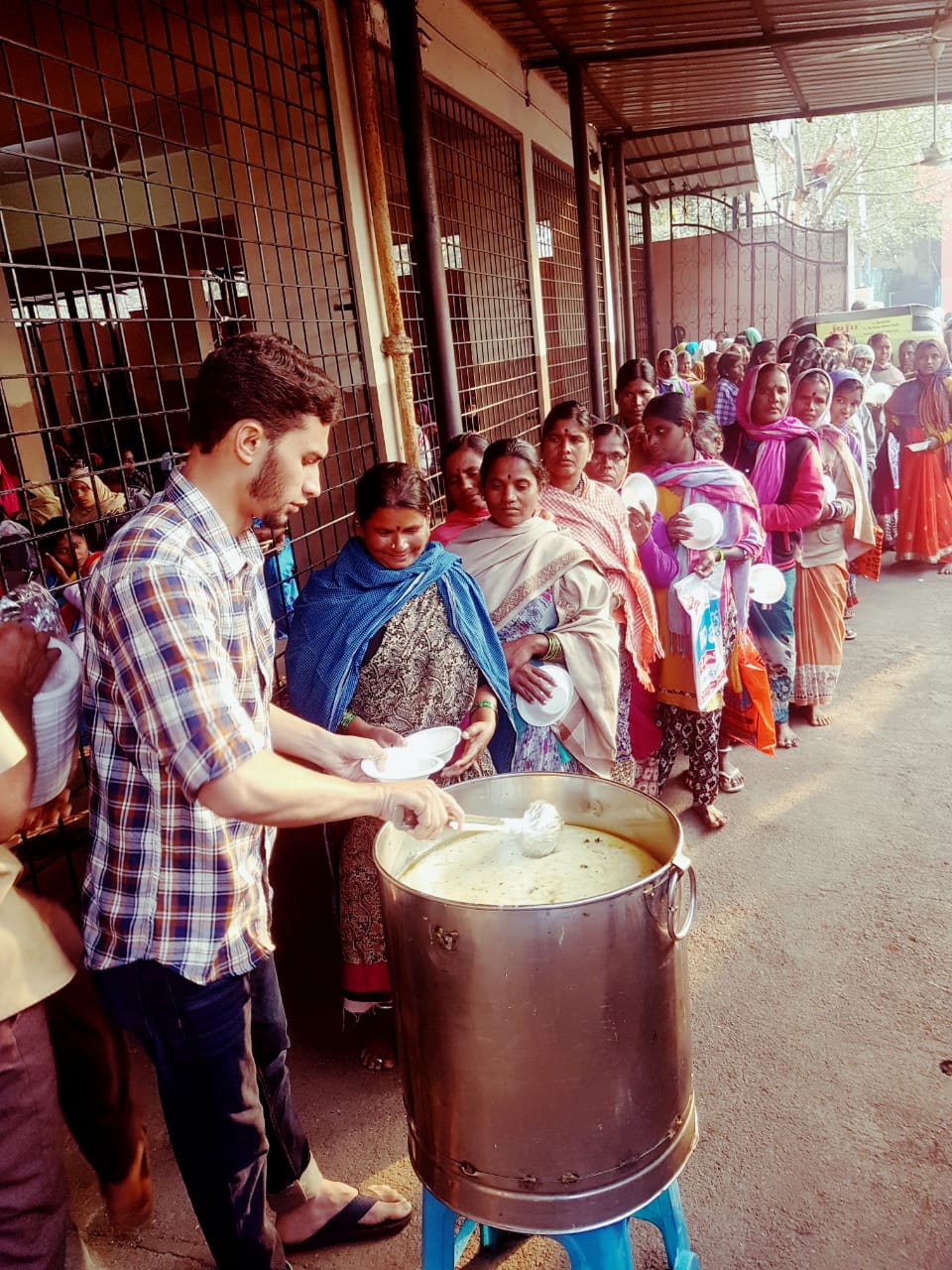 Serving breakfast outside the maternity hospital in Koti. 