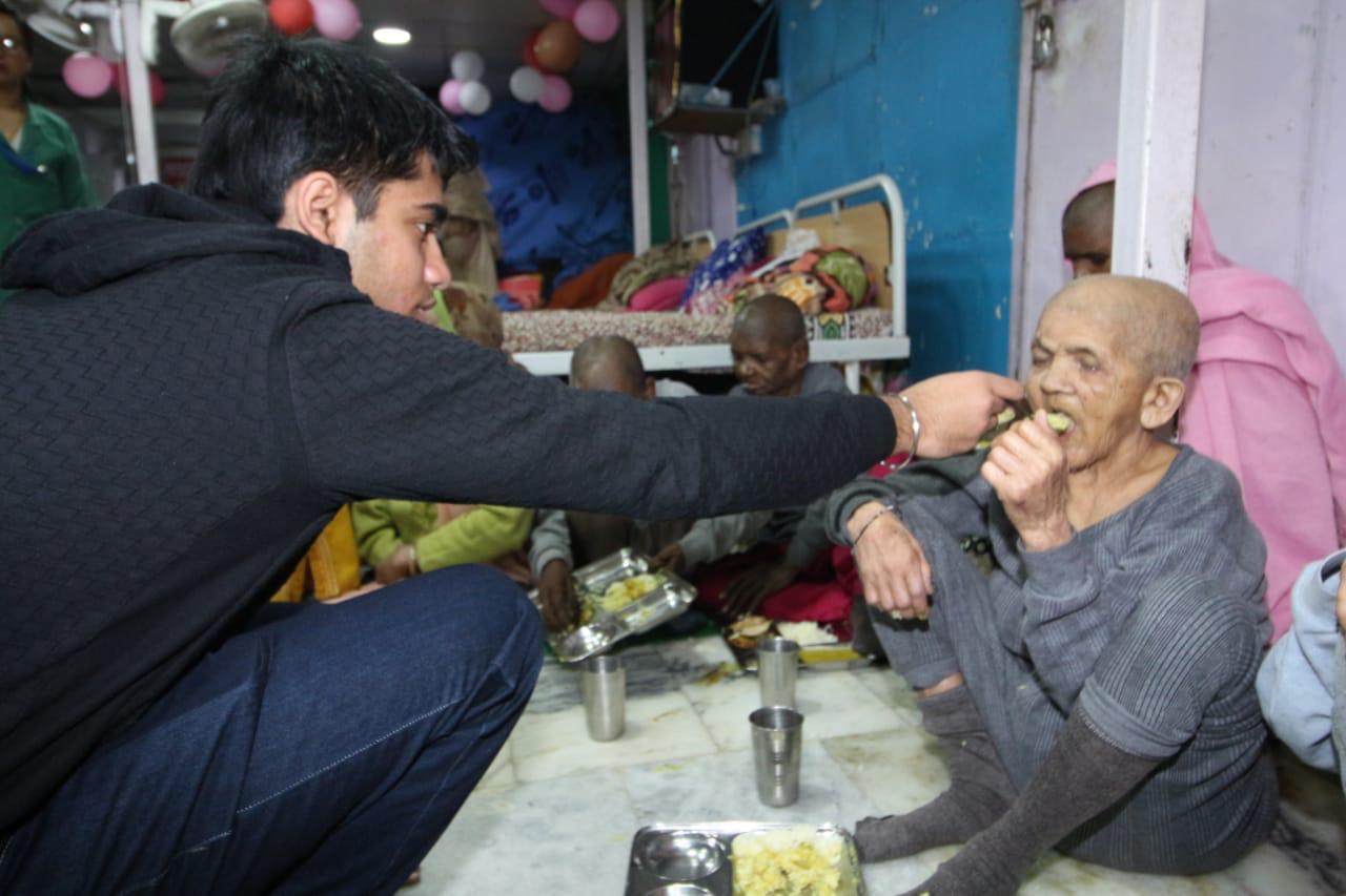 Vivhan feeding an elderly citizen. 