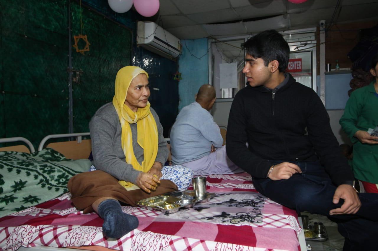 Vivhan sitting with an elderly citizen at the old age home. (Source: Vivhan)