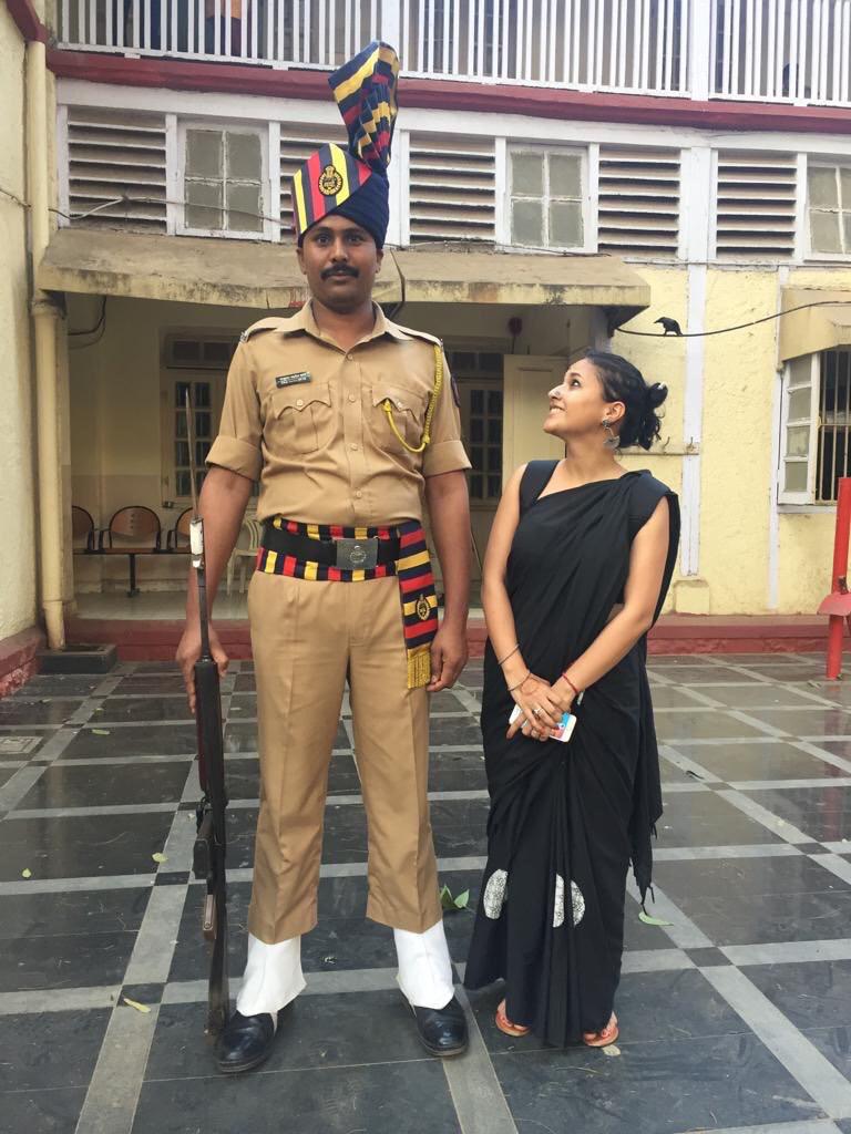 Sunchika Pandey (Right) standing next to a tall Mumbai cop. (Source: Sunchika Pandey)